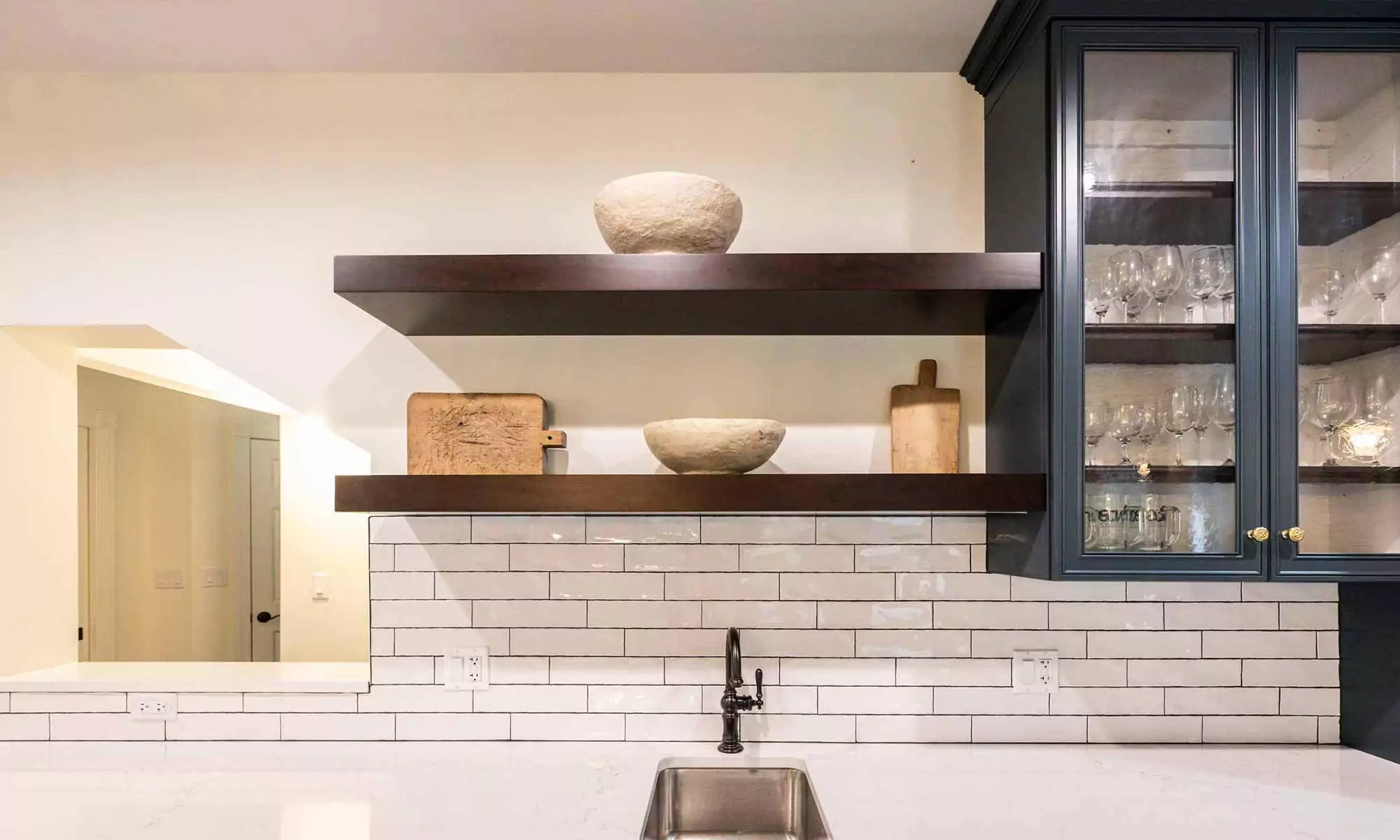 open wood shelves with white subway tile backsplash