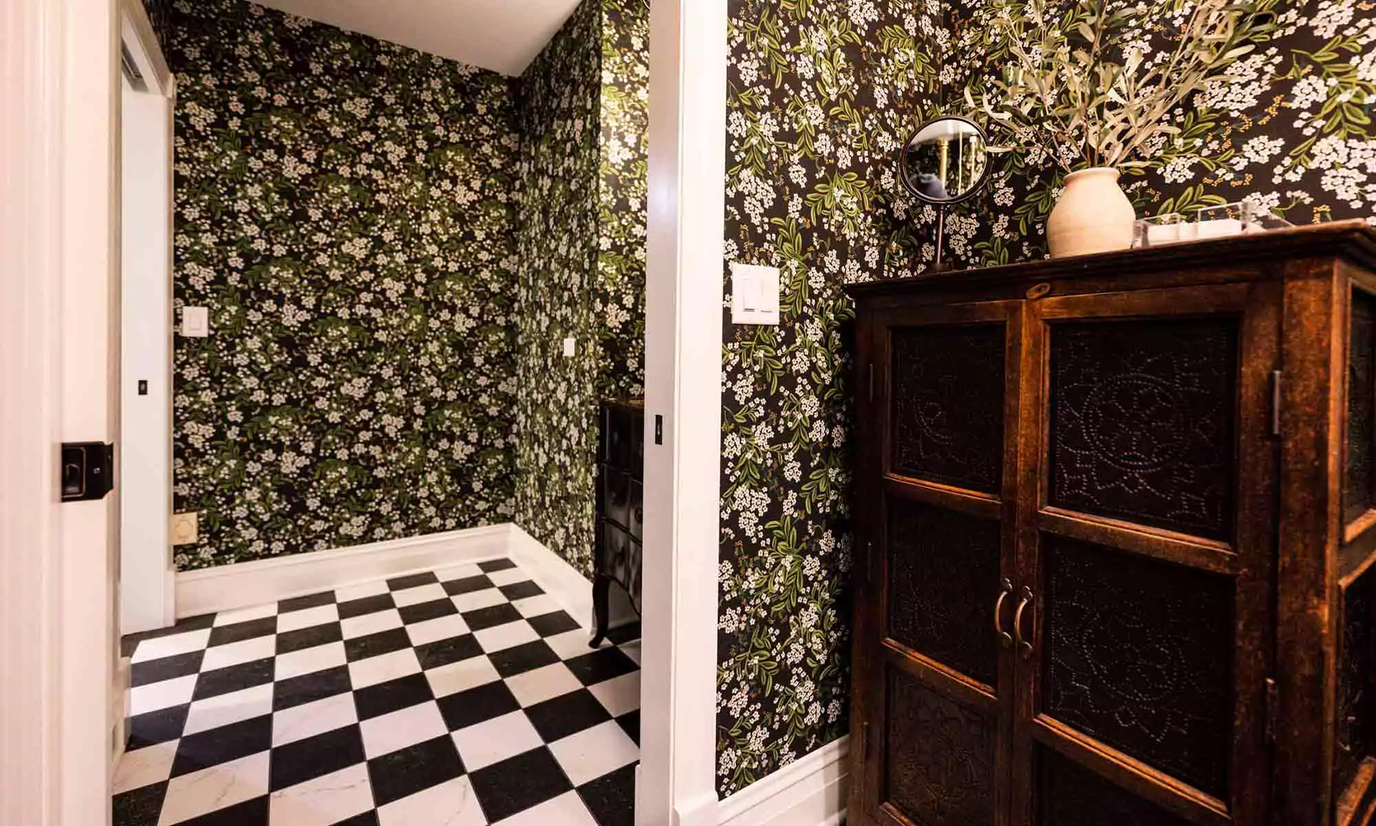 green textured wallpaper and checker board floors in luxury bathroom remodel