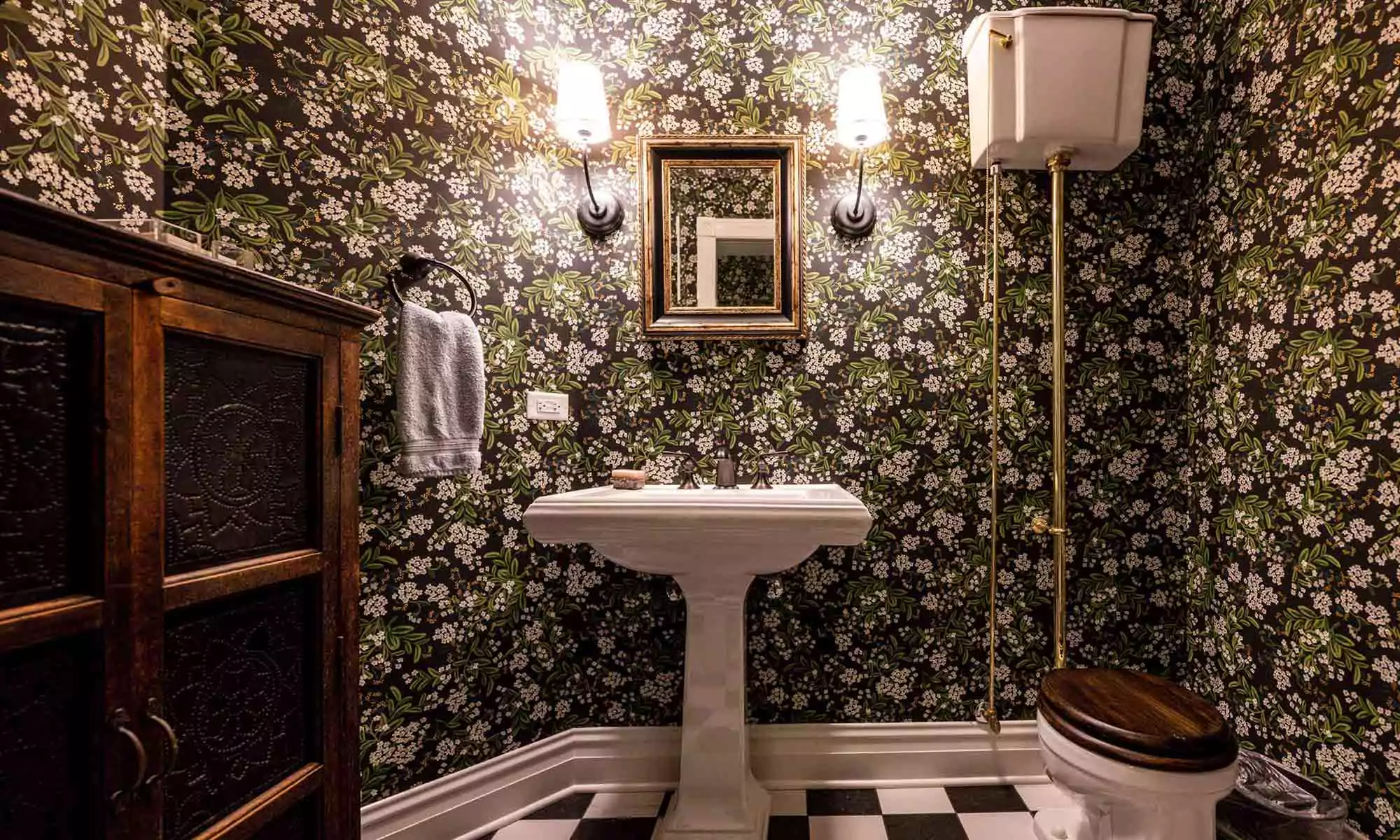 green textured wallpaper and checker board floors in luxury bathroom remodel