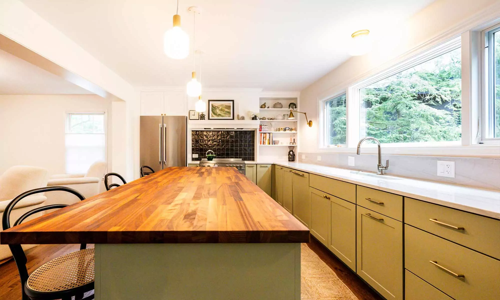 Family of five gathered around butcher block kitchen island in luxury kitchen remodel