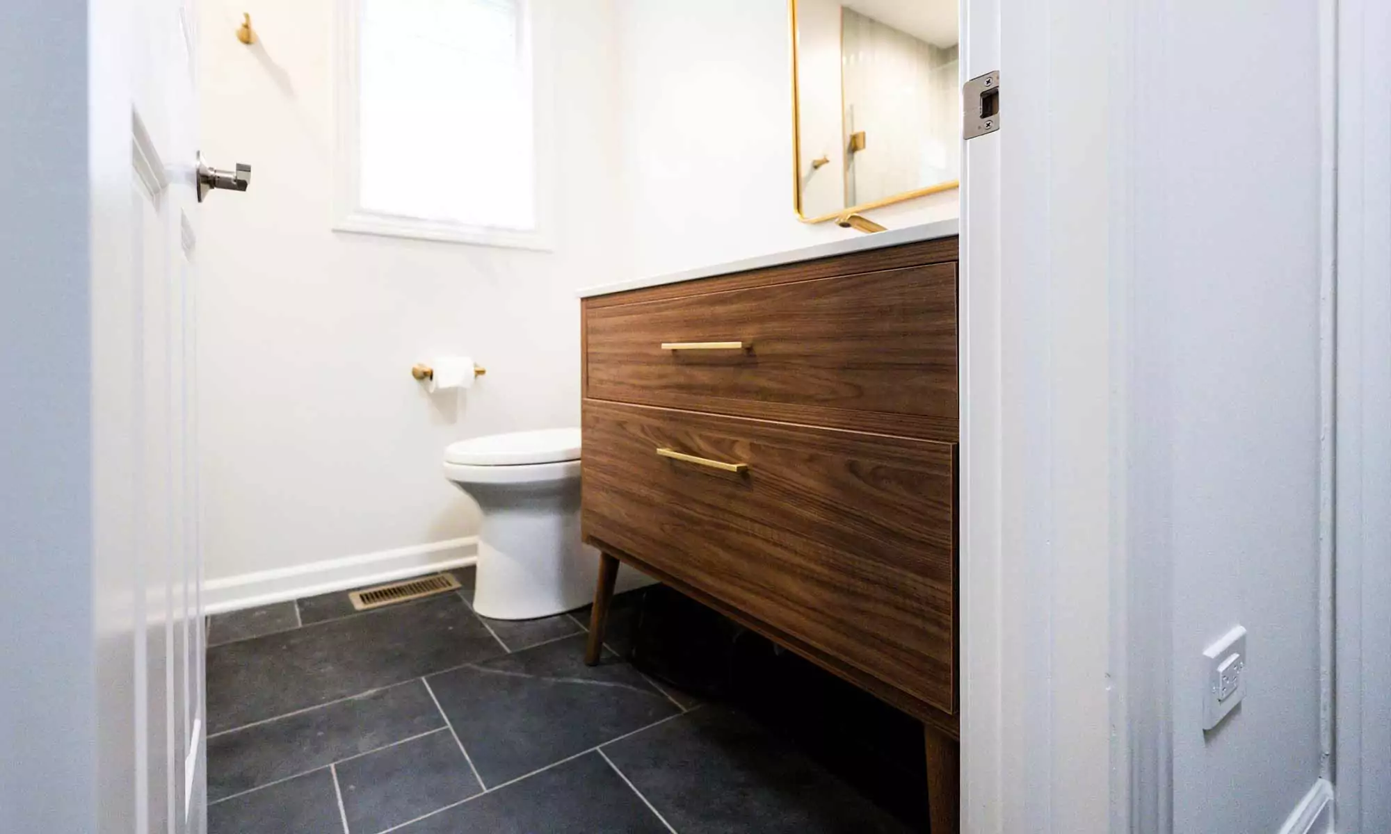 walnut island with slate floors in luxury bath remodel