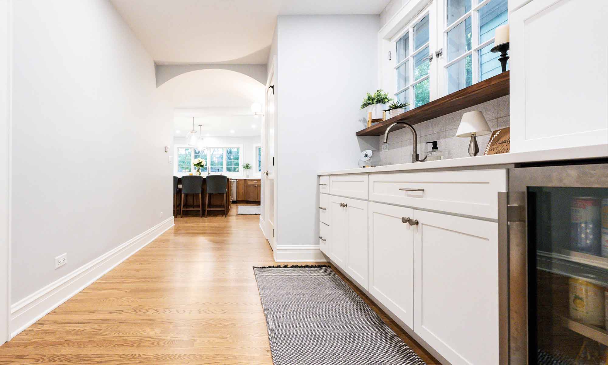 white cabinets in breakfast bar looking into kitchen addition