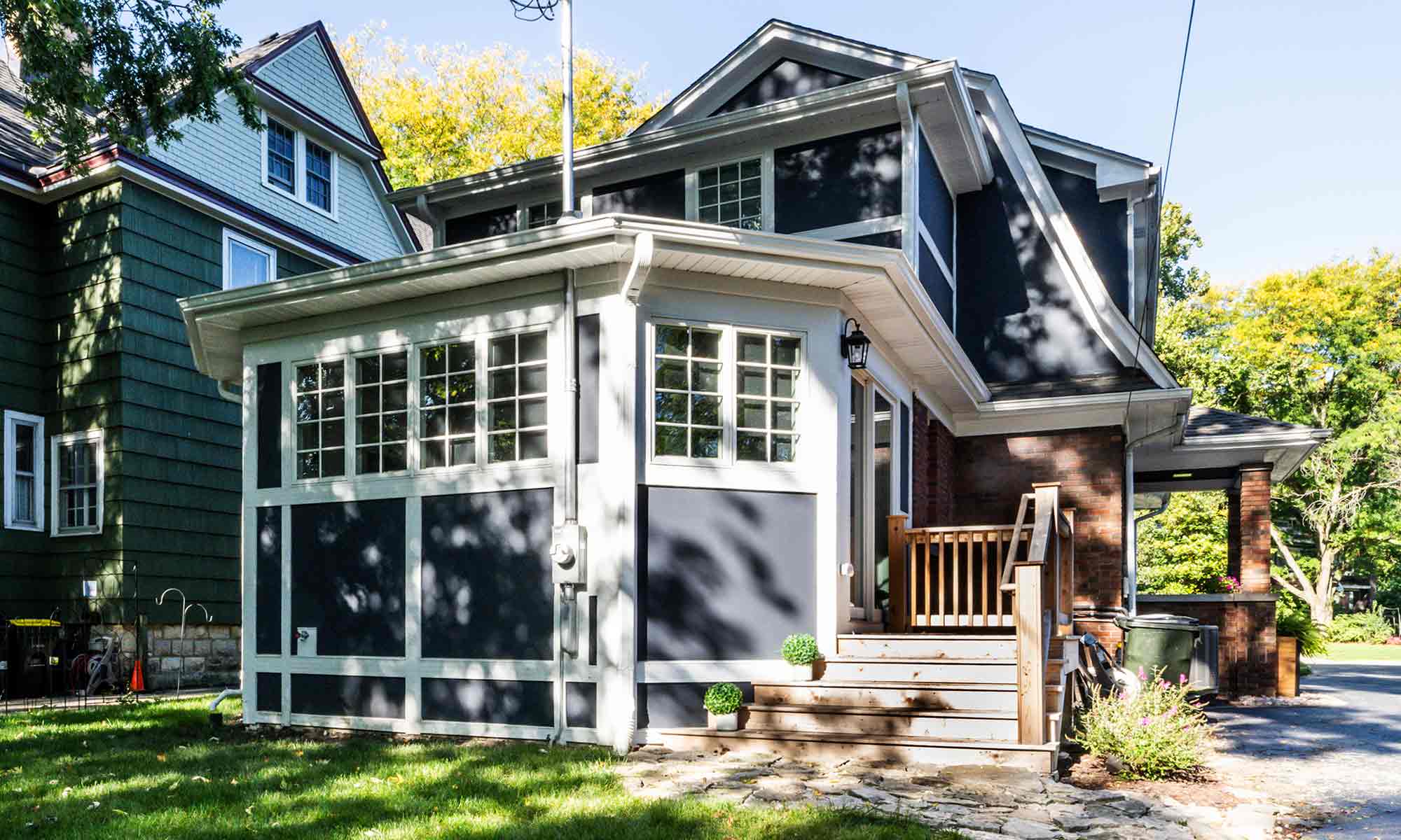 home addition with red brick and blue and white siding and trim