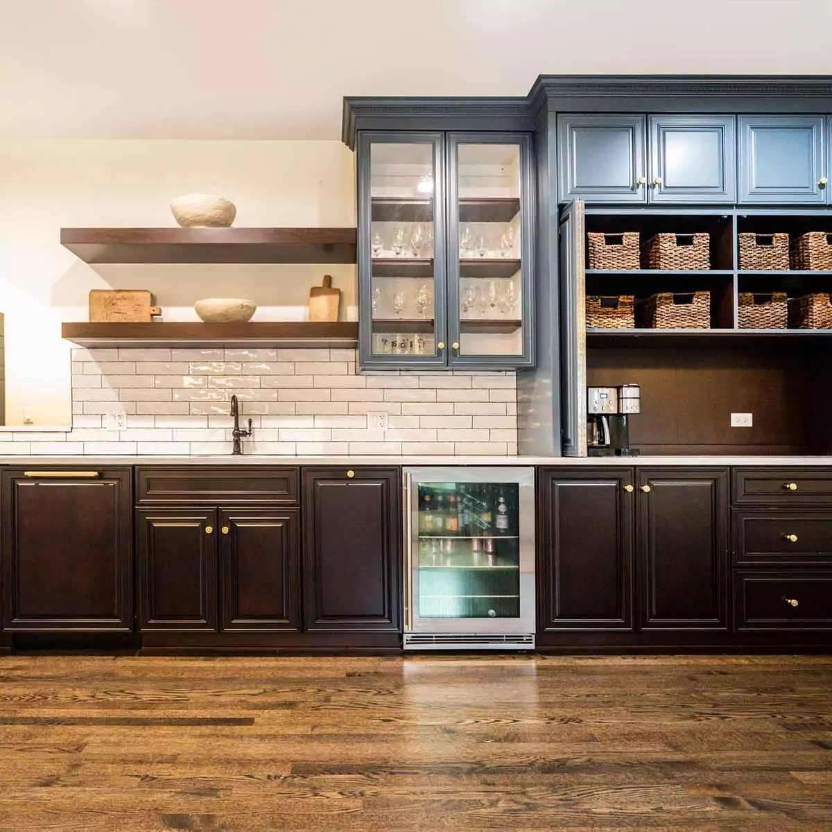 dark brown and slate blue kitchen cabinets with open shelves and basket storage