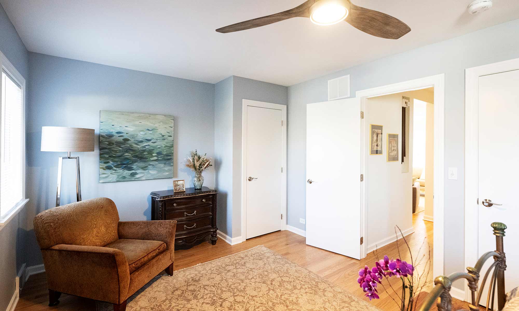 bedroom remodel with light blue walls and ceiling fan