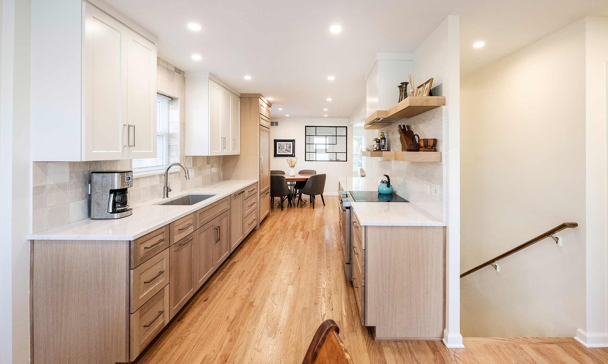 galley kitchen luxury remodel with white oak cabinets looking toward dining room