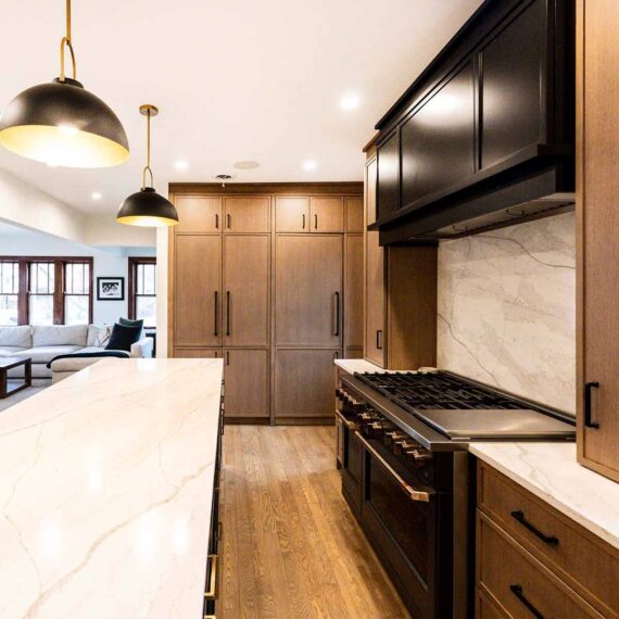 modern luxury kitchen remodel with white oak cabinets and dark grey appliances