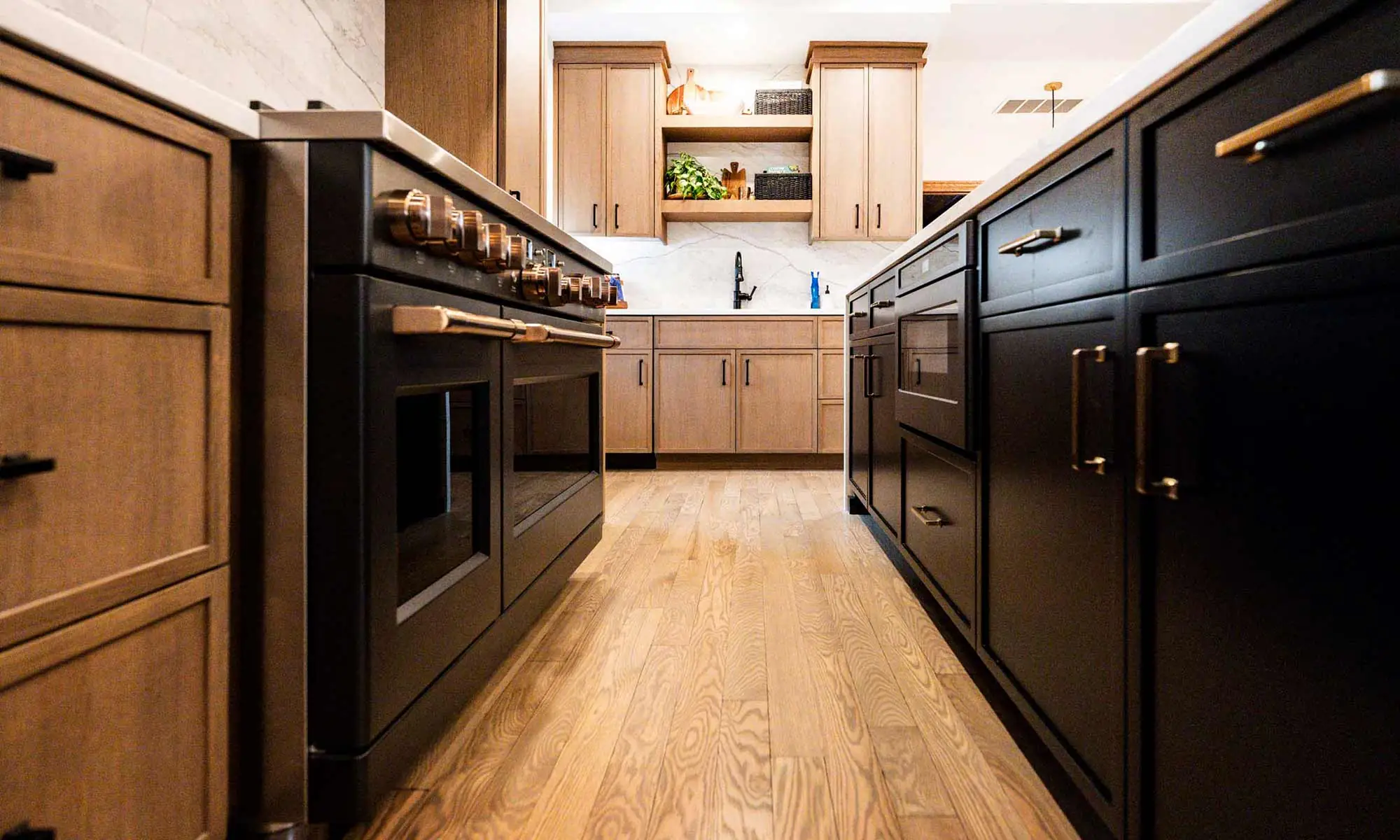 view of luxury kitchen remodel with windows flanking large range wall and white oak cabinetry