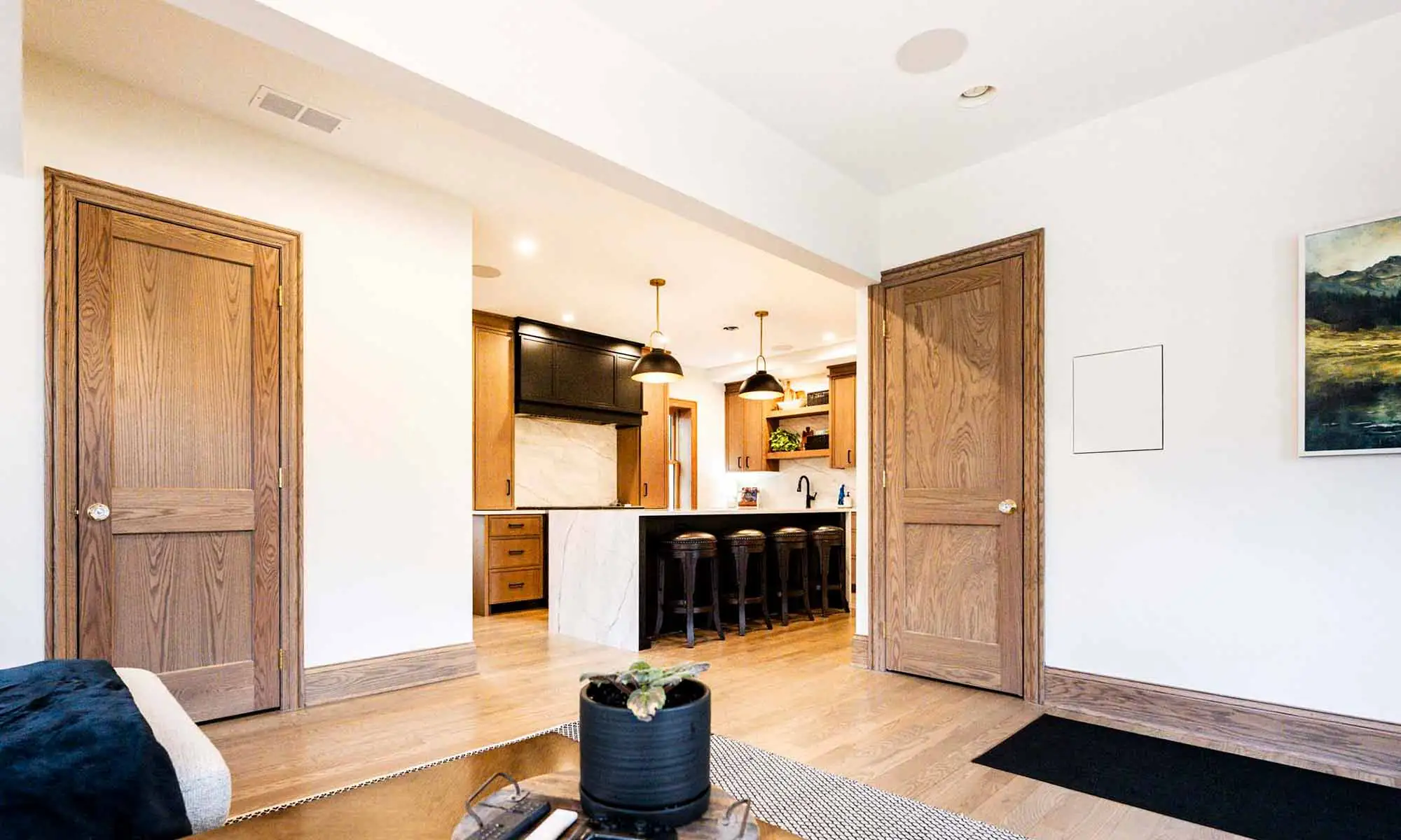 view of luxury kitchen remodel with island from family room and white oak cabinetry