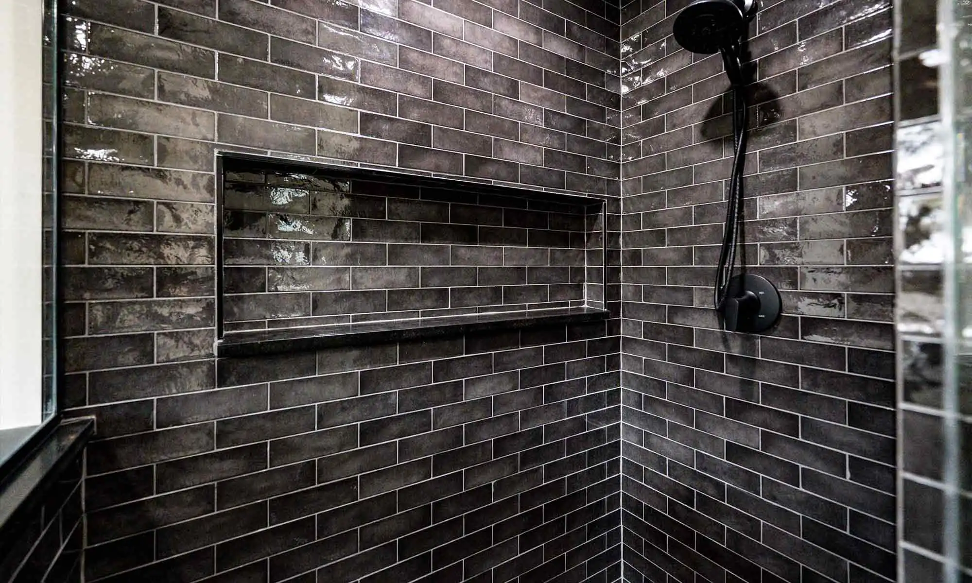 dark grey tile in luxury shower remodel with linear niche