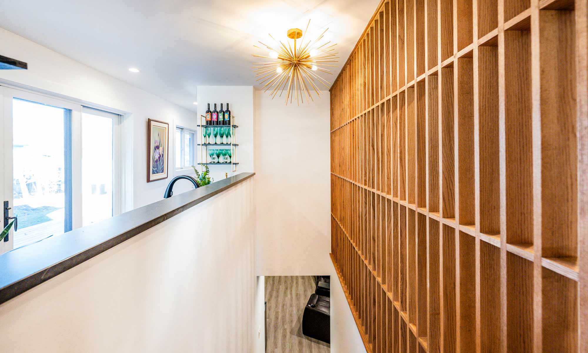 view of open wood slatted feature wall in oak along a basement stair