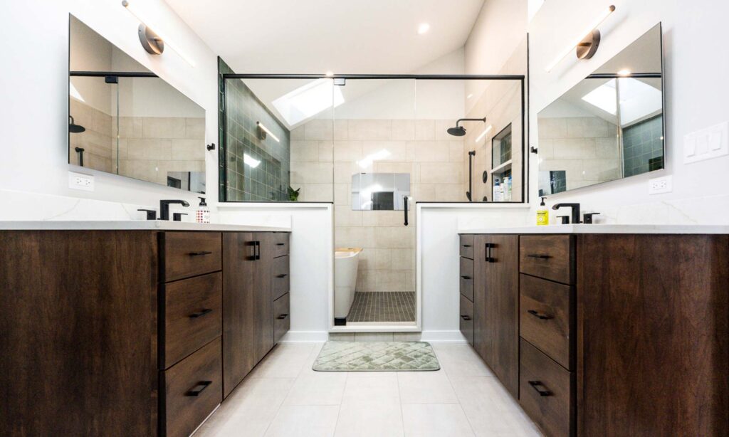 A stylish bathroom showcasing a walk-in shower alongside double sinks, combining functionality and contemporary design.