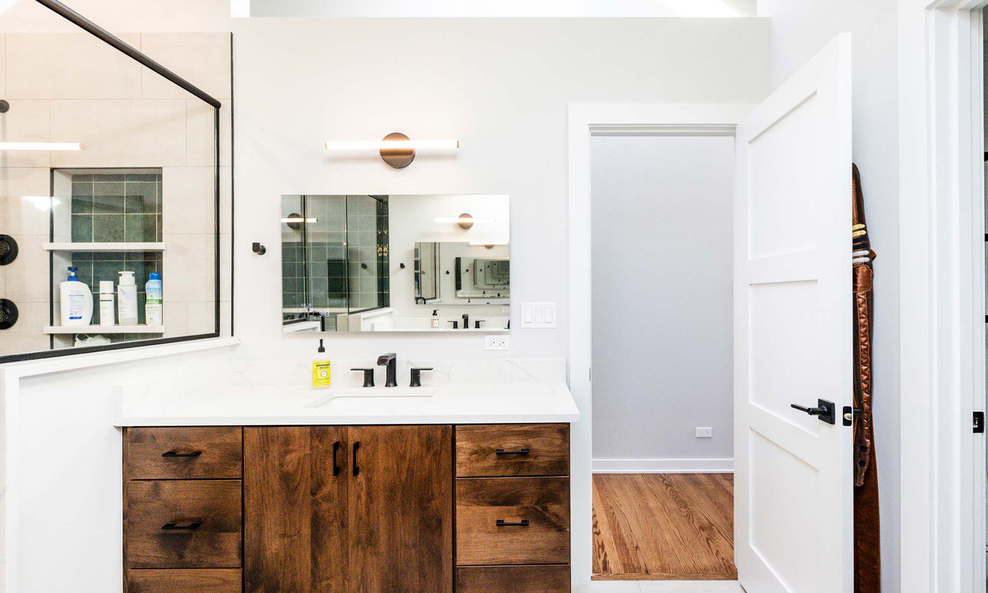 A bathroom featuring a shower and a blue tile floor, creating a serene and modern atmosphere.